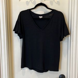 Black top with v-neck and ruffle sleeves